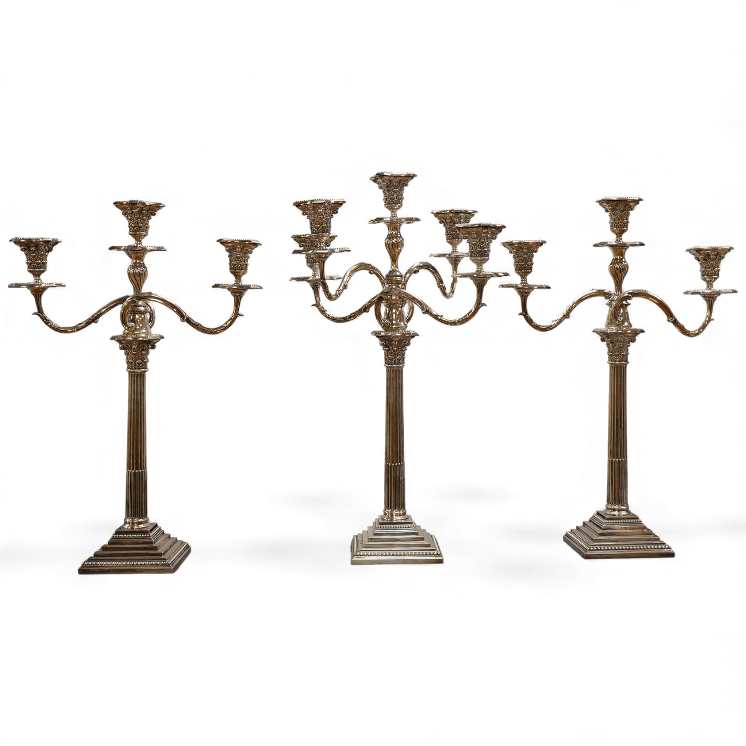A garniture of 19th century silver plated Corinthian column candelabra, comprising a pair of two branch, three light candelabra and matching four branch, five light candelabrum, with detachable acanthus leaf capped scrol